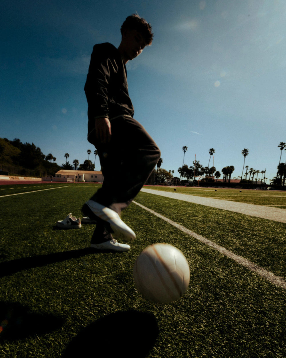 Player with the ball in the 323 Cleats